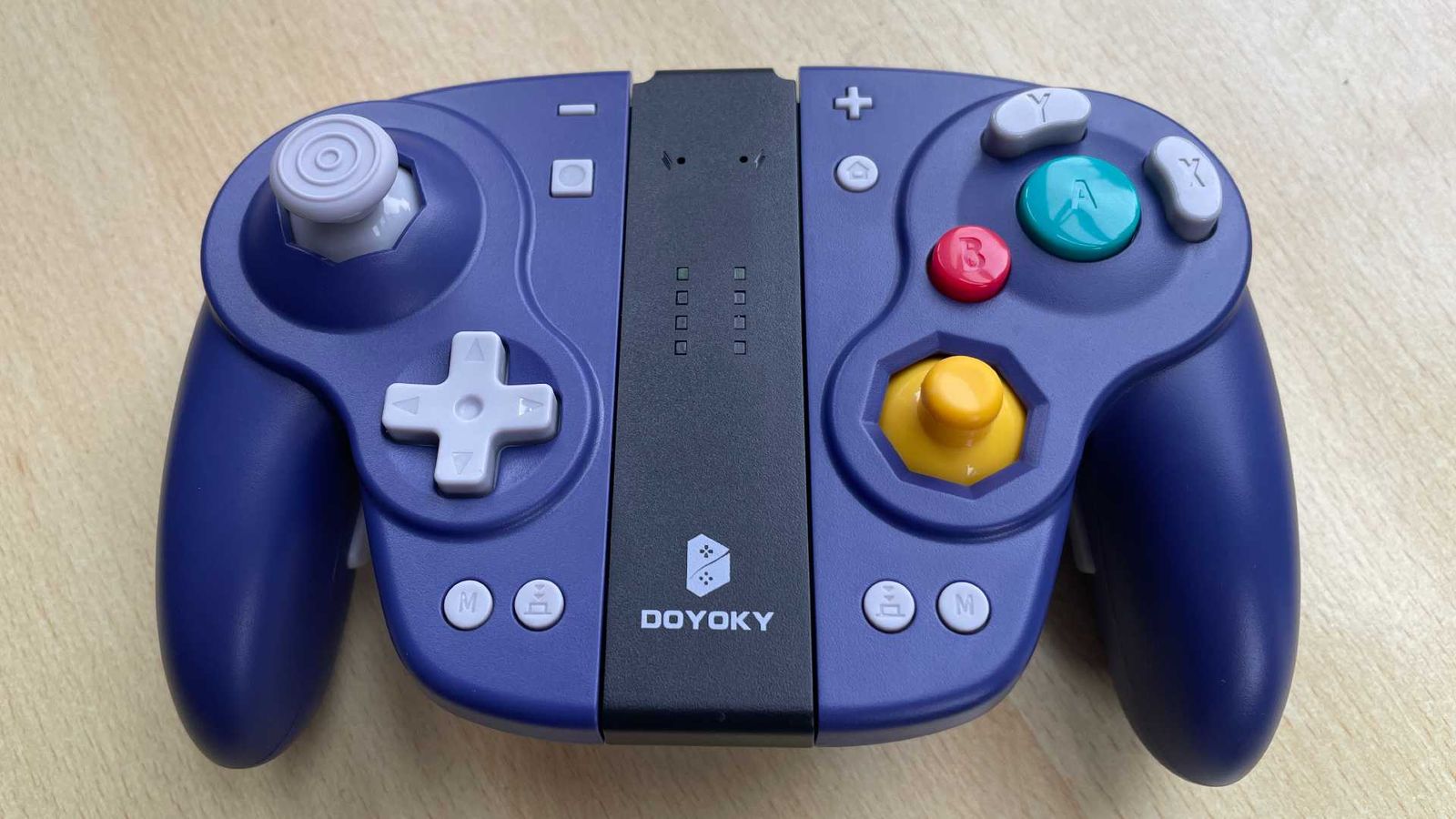 The DOYOKY Wireless Joy-Con retro game controller connected to its charging base.